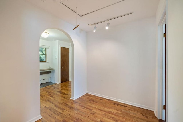 51 Strong Rd, Ferndale, NY 12734 - unfurnished room featuring track lighting, wood finished floors, attic access, and a baseboard radiator
