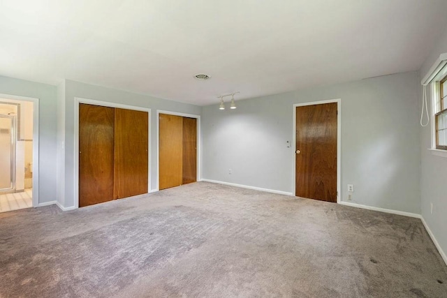 51 Strong Rd, Ferndale, NY 12734 - unfurnished bedroom featuring two closets, baseboards, ensuite bathroom, and carpet