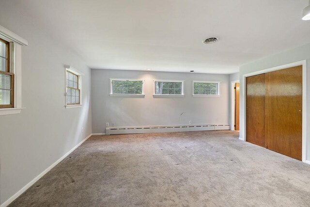51 Strong Rd, Ferndale, NY 12734 - empty room with visible vents, a baseboard heating unit, a wealth of natural light, and carpet