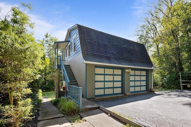 51 Strong Rd, Ferndale, NY 12734 - view of side of property featuring a garage, a shingled roof, a gambrel roof, and stairway