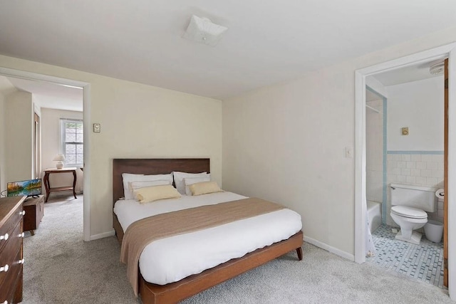 51 Strong Rd, Ferndale, NY 12734 - bedroom featuring baseboards, tile walls, light carpet, and ensuite bath