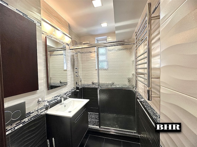 full bath featuring vanity, a shower stall, and tile patterned floors