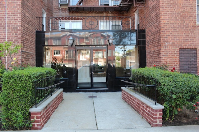 view of exterior entry featuring brick siding