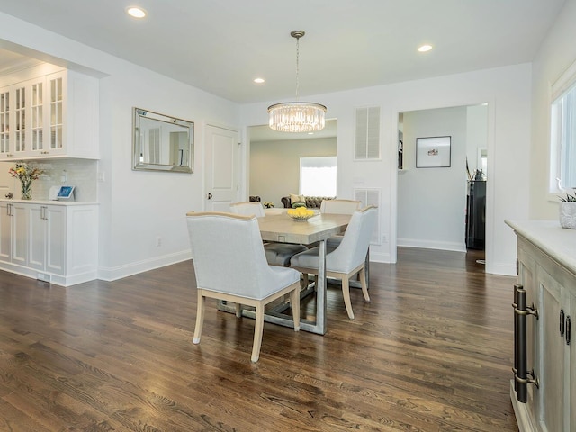 dining space featuring a chandelier, plenty of natural light, dark wood-style flooring, and recessed lighting