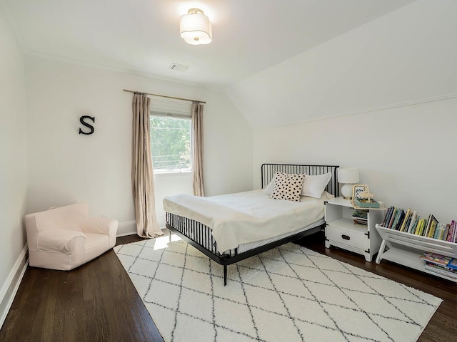 bedroom featuring wood finished floors, baseboards, and lofted ceiling