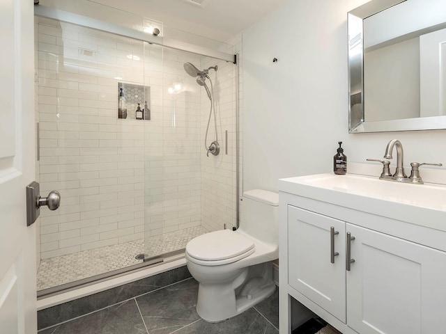 full bathroom featuring toilet, a stall shower, tile patterned floors, and vanity