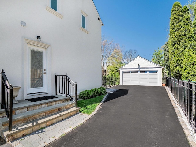 detached garage featuring fence