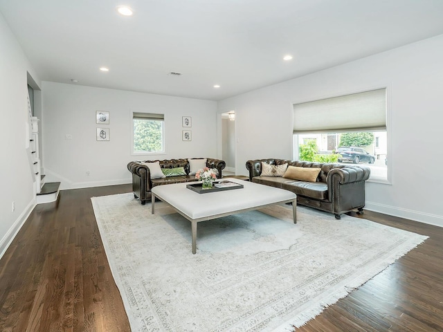 living room with healthy amount of natural light, recessed lighting, dark wood finished floors, and baseboards