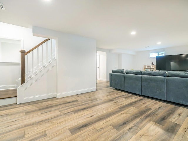 living area featuring light wood-style flooring, stairway, recessed lighting, and baseboards