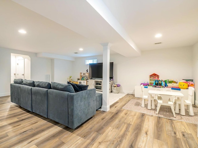living room featuring wood finished floors, recessed lighting, and baseboards