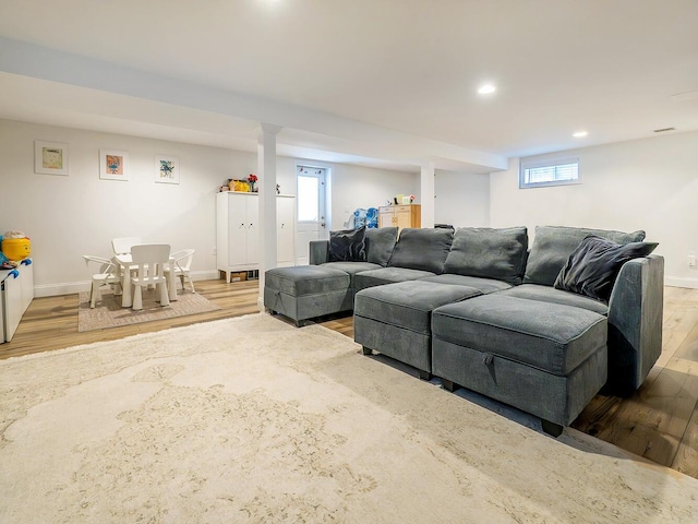 living room featuring wood finished floors, baseboards, and recessed lighting