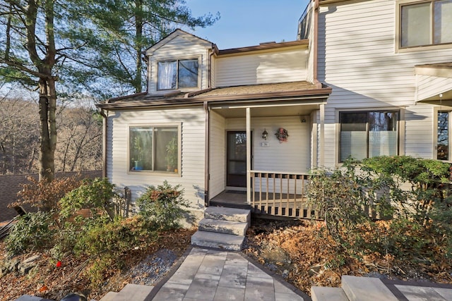 view of exterior entry with covered porch