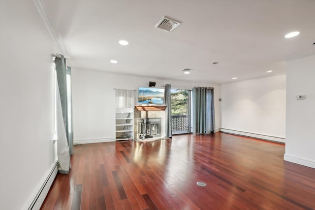 spare room with visible vents, wood finished floors, recessed lighting, a baseboard heating unit, and a baseboard radiator