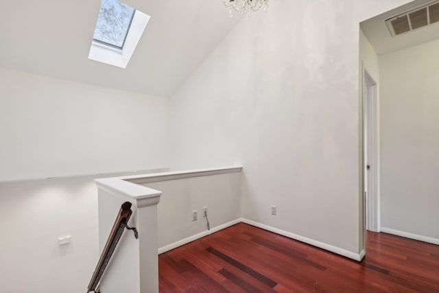 bonus room with baseboards, wood finished floors, and visible vents