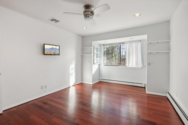 unfurnished bedroom with wood finished floors, ceiling fan, a baseboard heating unit, and visible vents