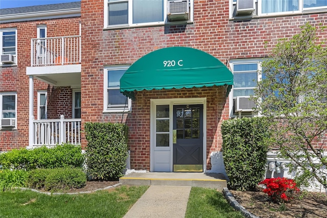 entrance to property featuring brick siding