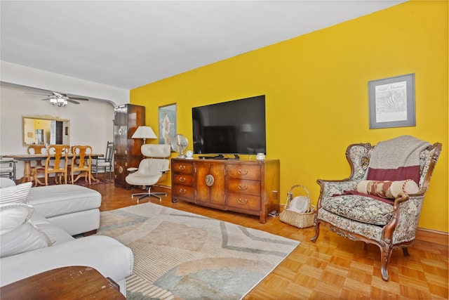 living area featuring a ceiling fan