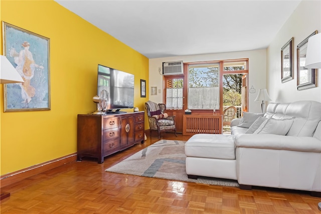living area featuring radiator heating unit and an AC wall unit