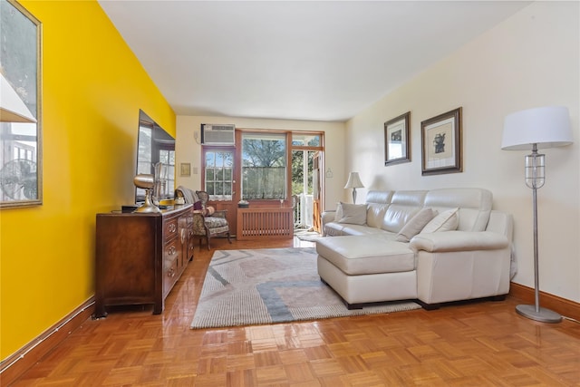 living room with baseboards, a wall mounted air conditioner, and radiator heating unit