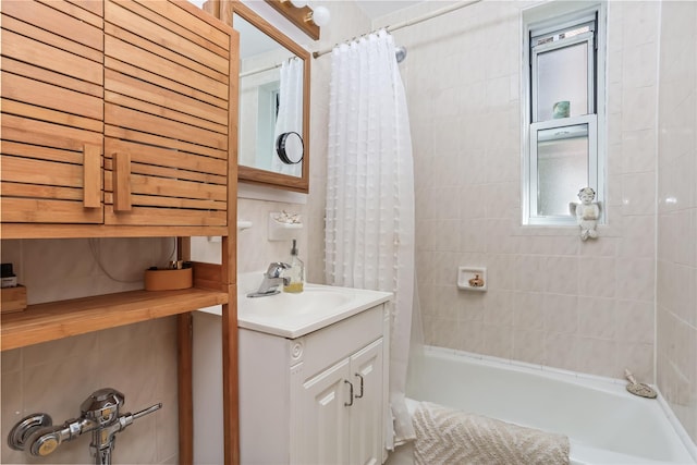 bathroom featuring vanity and shower / bath combination with curtain