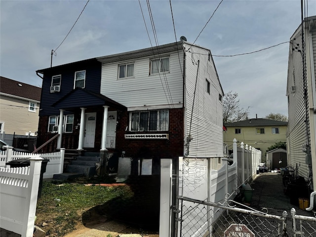 view of front of house featuring brick siding and fence private yard