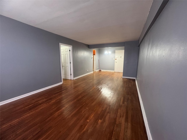 empty room with wood finished floors and baseboards