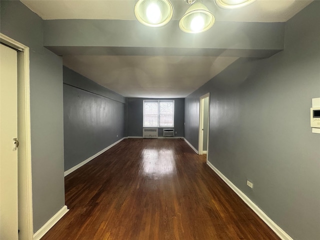 empty room with wood finished floors and baseboards