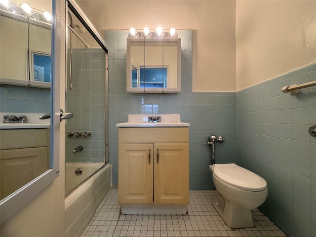 full bathroom featuring tile walls, tile patterned flooring, toilet, shower / tub combination, and vanity