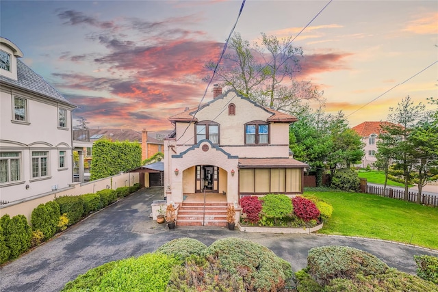 14-35 161st St, Beechhurst, NY 11357 - view of front facade featuring fence, stucco siding, driveway, and a lawn