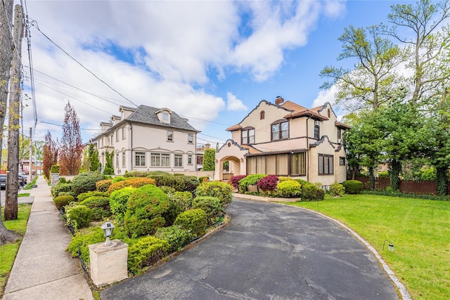 14-35 161st St, Beechhurst, NY 11357 - tudor house with a front lawn, stucco siding, and fence