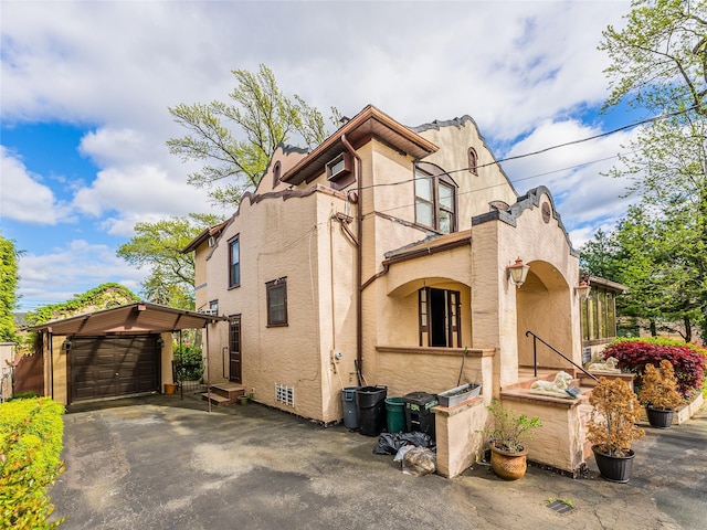 14-35 161st St, Beechhurst, NY 11357 - view of side of property with an outdoor structure, a garage, stucco siding, and aphalt driveway