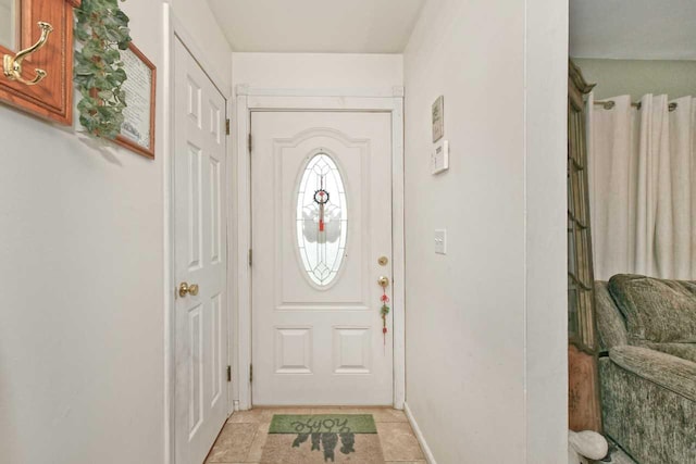 entryway featuring baseboards and light tile patterned floors