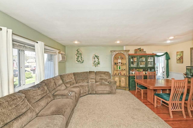 living area with recessed lighting, wainscoting, and wood finished floors