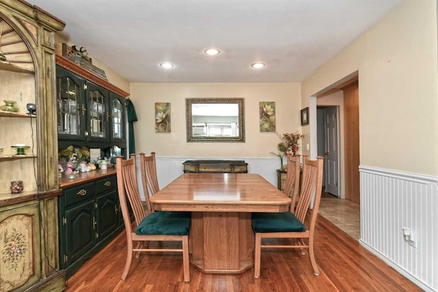 dining room featuring recessed lighting, wainscoting, and wood finished floors
