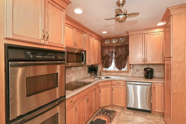 kitchen with light countertops, stainless steel appliances, a ceiling fan, and a sink