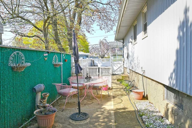 balcony featuring outdoor dining space and a patio area