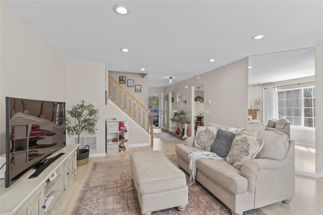 living room featuring light wood-style floors, recessed lighting, a healthy amount of sunlight, and visible vents