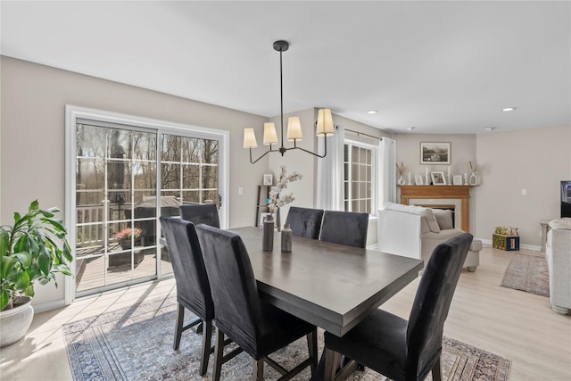 dining area featuring recessed lighting, a chandelier, and light wood finished floors