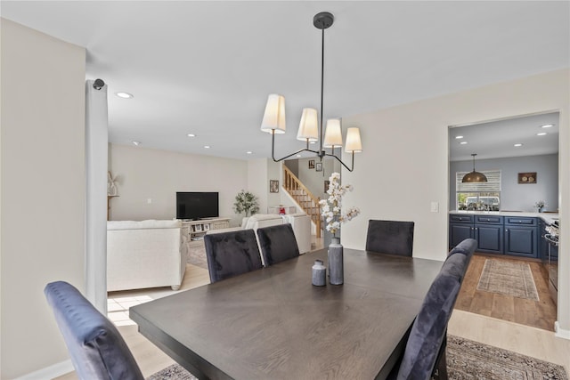 dining area featuring recessed lighting, light wood-style flooring, and stairway