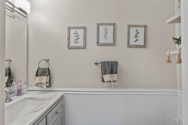bathroom with vanity and wainscoting