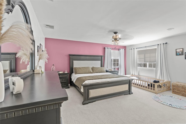 bedroom with a ceiling fan, carpet flooring, and visible vents