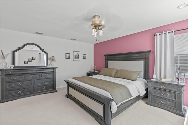 carpeted bedroom with ceiling fan and visible vents