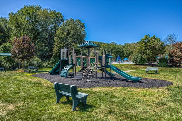 communal playground featuring a yard