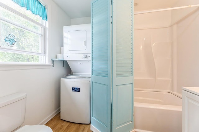 159 S Harrison Ave, Congers, NY 10920 - full bath with estacked washer and dryer, toilet, wood finished floors, baseboards, and bathing tub / shower combination