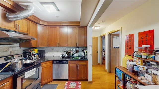 143-36 37th Ave Unit 5C, Flushing, NY 11354 - kitchen featuring under cabinet range hood, backsplash, appliances with stainless steel finishes, and light wood finished floors