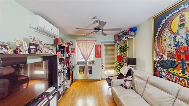 143-36 37th Ave Unit 5C, Flushing, NY 11354 - living room featuring a wall mounted air conditioner, light wood finished floors, a ceiling fan, and baseboards