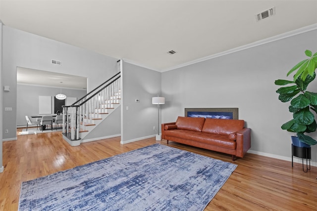 3 Kings Dr, Middletown, NY 10941 - living area with stairway, wood finished floors, crown molding, and baseboards