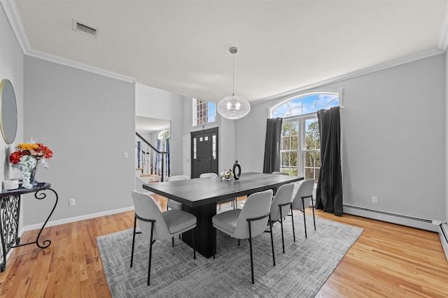 3 Kings Dr, Middletown, NY 10941 - dining area with stairs, crown molding, light wood-style flooring, baseboard heating, and baseboards
