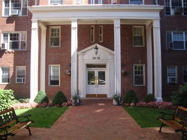 exterior space with a porch, french doors, and brick siding