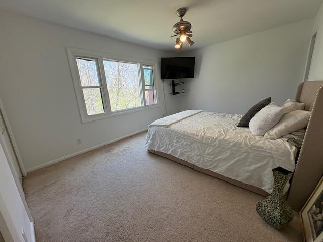 carpeted bedroom featuring baseboards